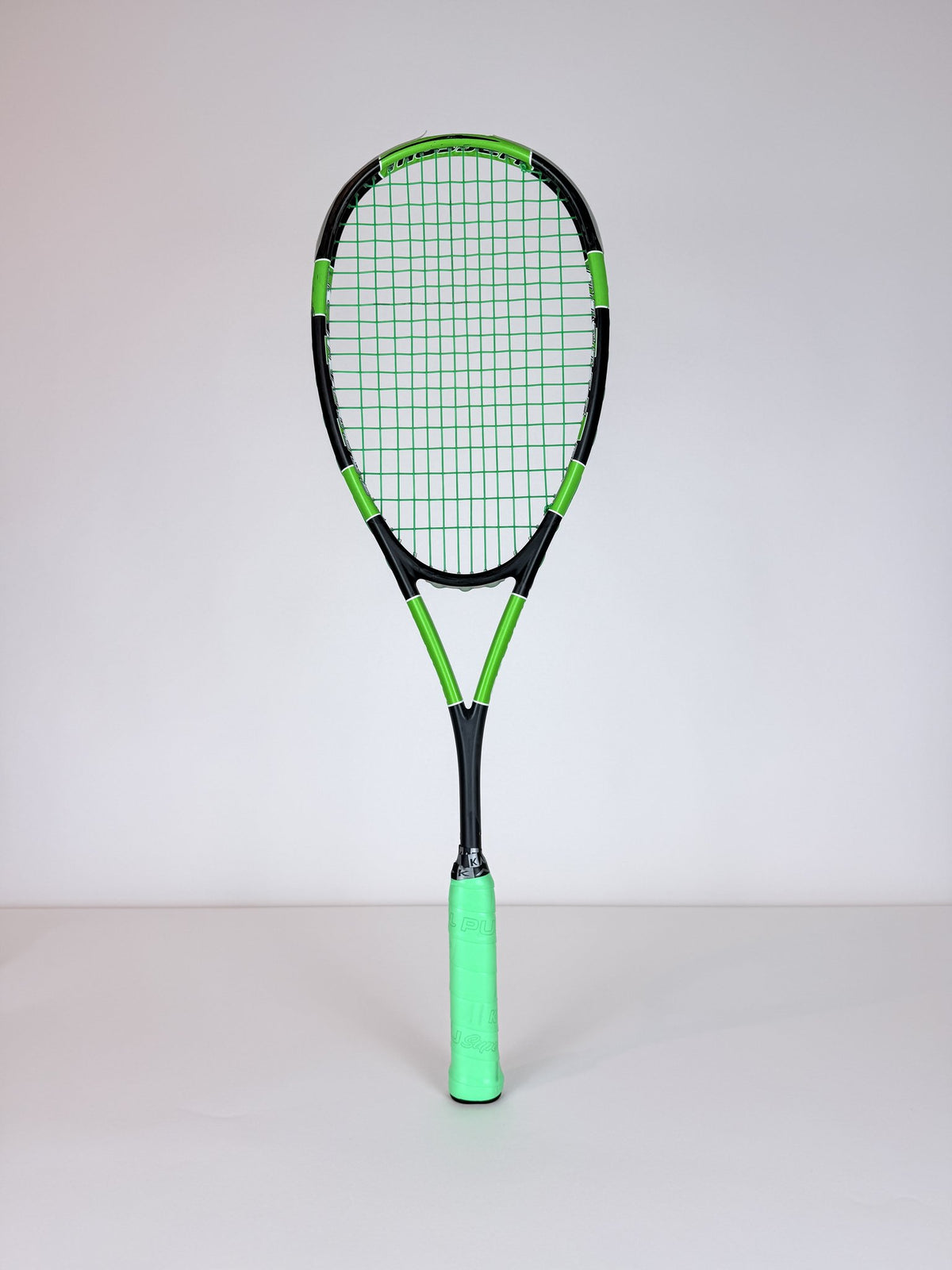 Lightly used Harrow Spark squash racket, front view