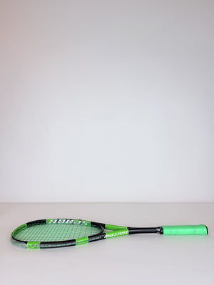 Lightly used Harrow Spark squash racket, lying on its side